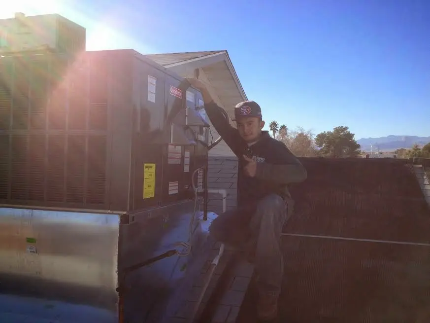 HVAC technician performing HVAC Inspection on a rooftop unit in Crystal Lake